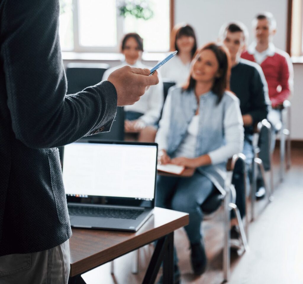 multisite certification - a group of people sitting in a training session