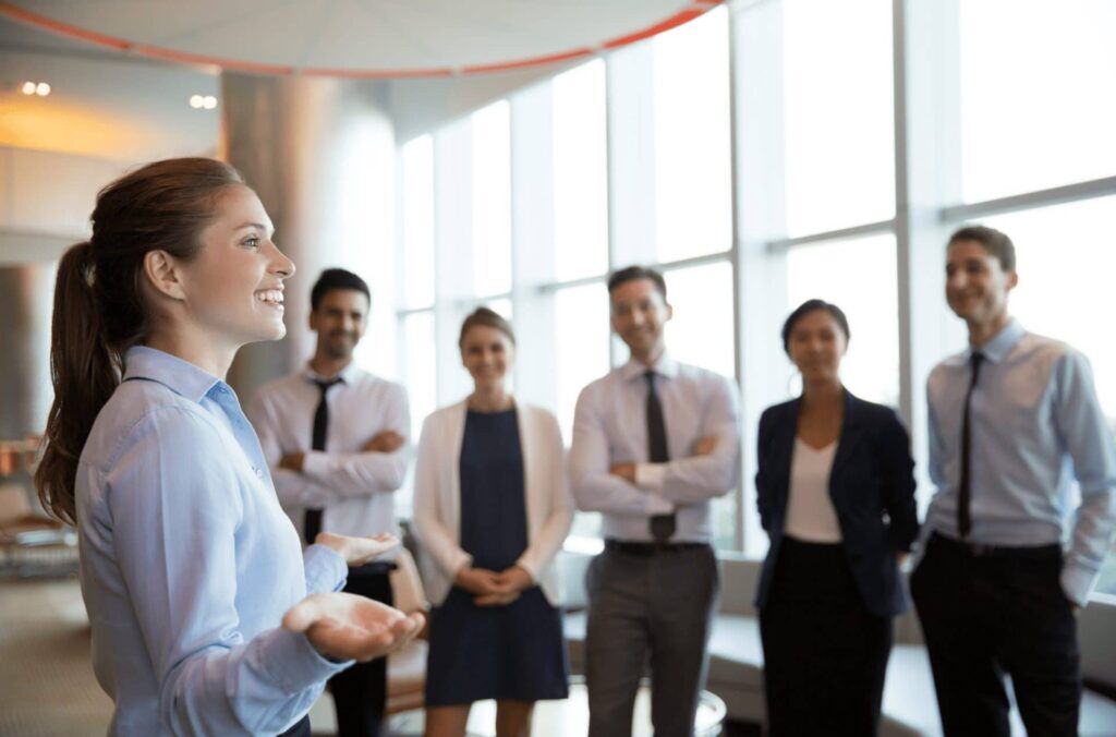 multisite certification - a woman at work talking to her team