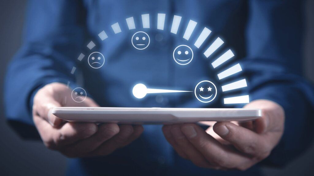 multisite certification - a man holding a tablet featuring a customer satisfaction chart