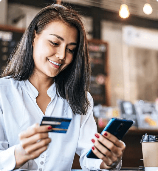 CR2 case study - woman looking at bank card and smartphone