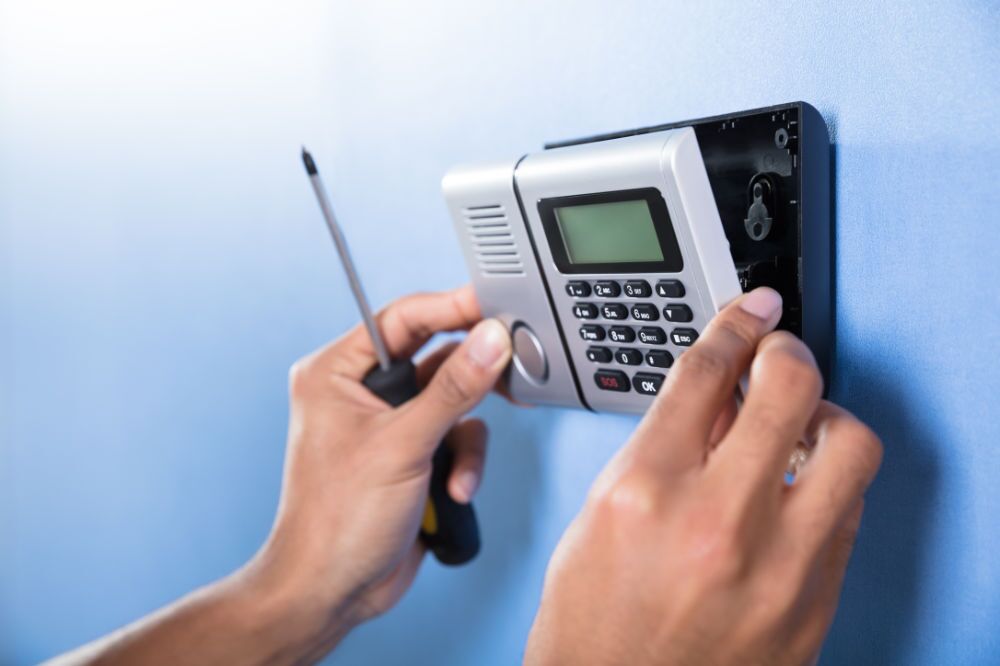 Amtivo (Formerly Certification Europe and EQA) - Close-up of a worker installing an access control panel