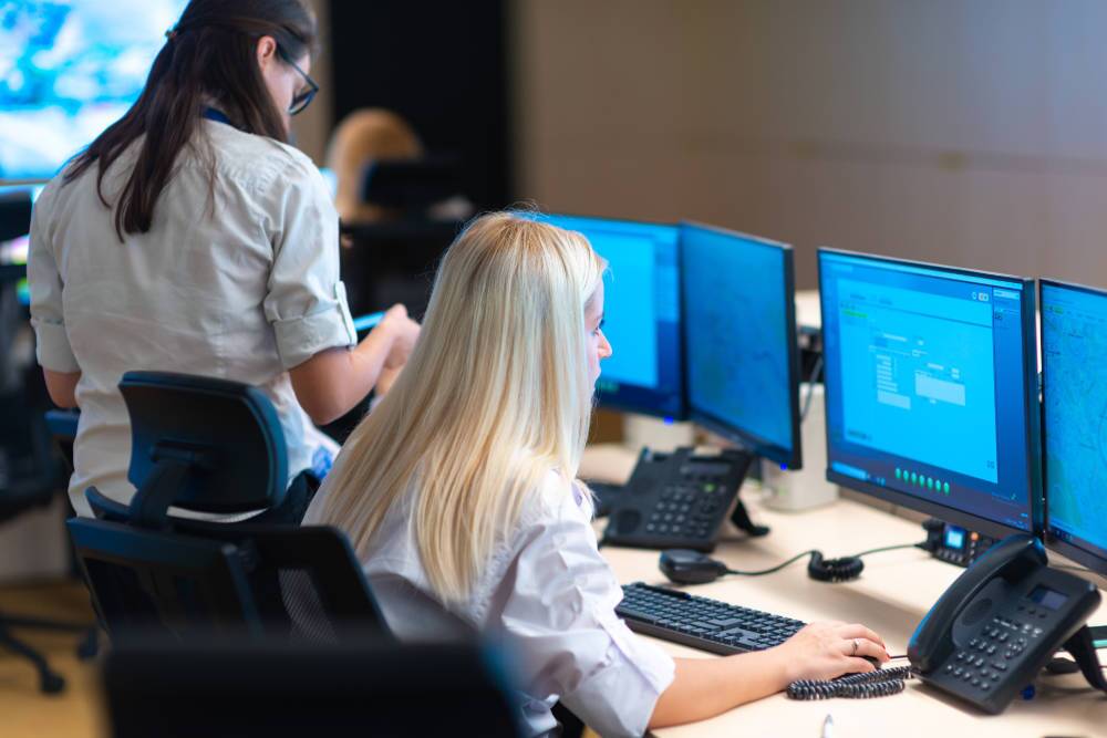 Amtivo (Formerly Certification Europe and EQA) - Alarm Monitoring - Workers at their desk monitoring the computer screens Workers in an alarm receiving centre