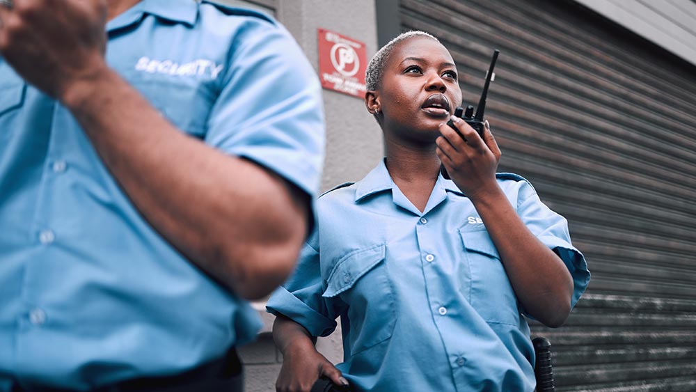 Amtivo (Formerly Certification Europe and EQA) - manned guarding - Two security guards on walkie talkies.